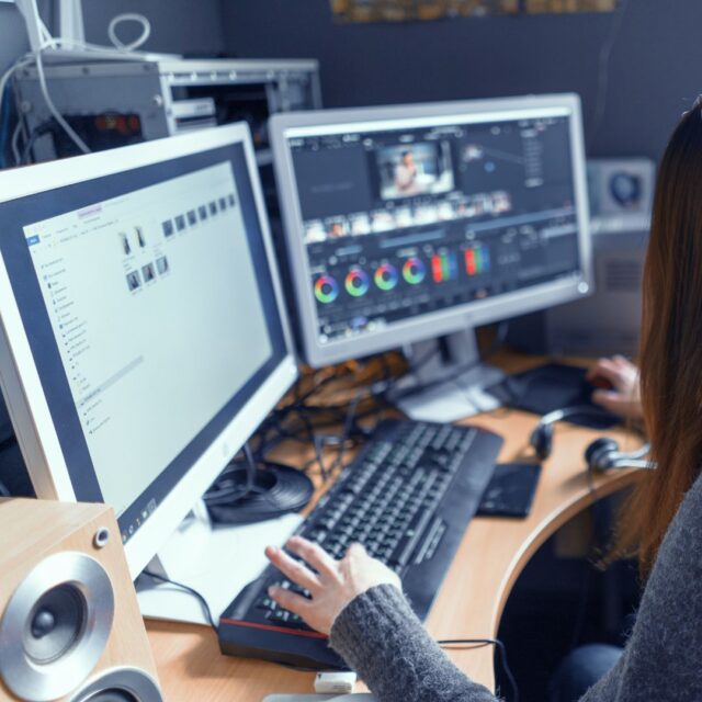 Showcasing Your Expertise: Elevating Your Website with Educational Content 2 a woman sitting at a desk with two computer monitors