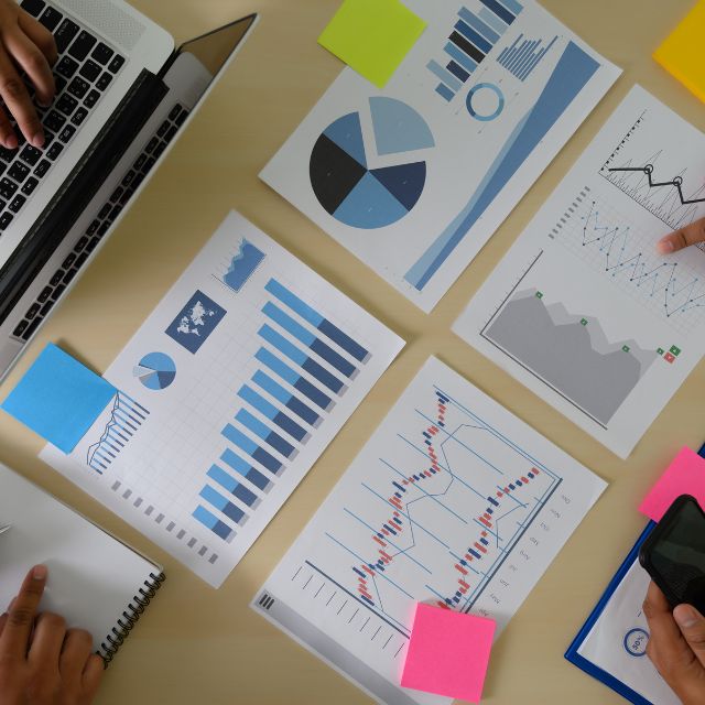 SEO Success Starts Here: A Comprehensive Keyword Research Guide 3 a group of people working on a laptop and papers